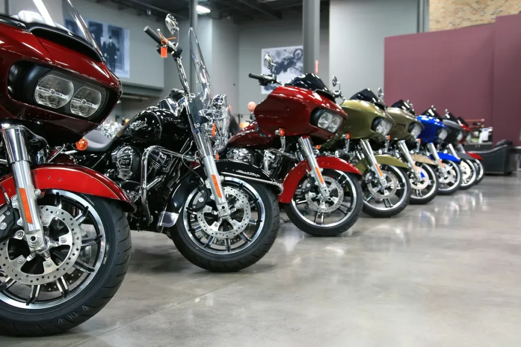 Row of new touring motorcycles lined up on a dealership showroom floor