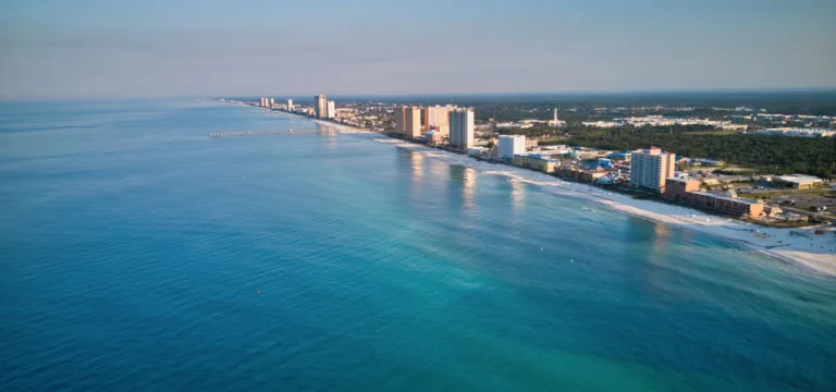 Aerial view of Panama City Beach, home of the Thunder Beach rally: emerald Gulf water, white sand, condos and the pier